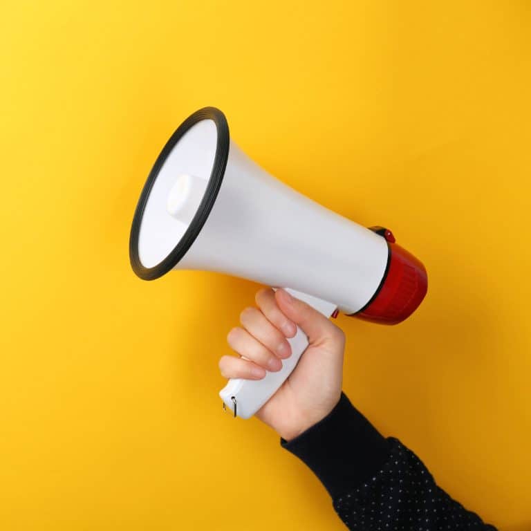 A picture of a megaphone against a yellow background. This represents sharing to support small businesses